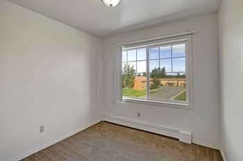 A bedroom with overhead lighting and a wide window The Glen Bedroom - Photo Gallery 4