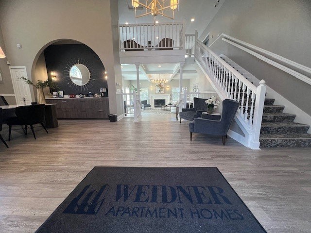a living room with a rug and a staircase