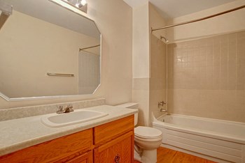 A bathroom with a shower, tub, and mirror over the sink Property Image