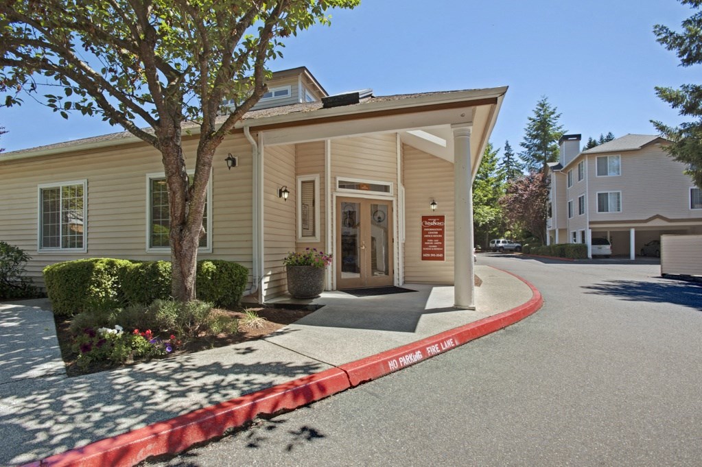 A small building with a red curb in front of it.