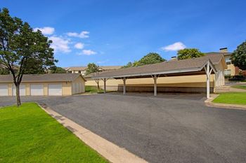 a house with a garage and a tree in front of it