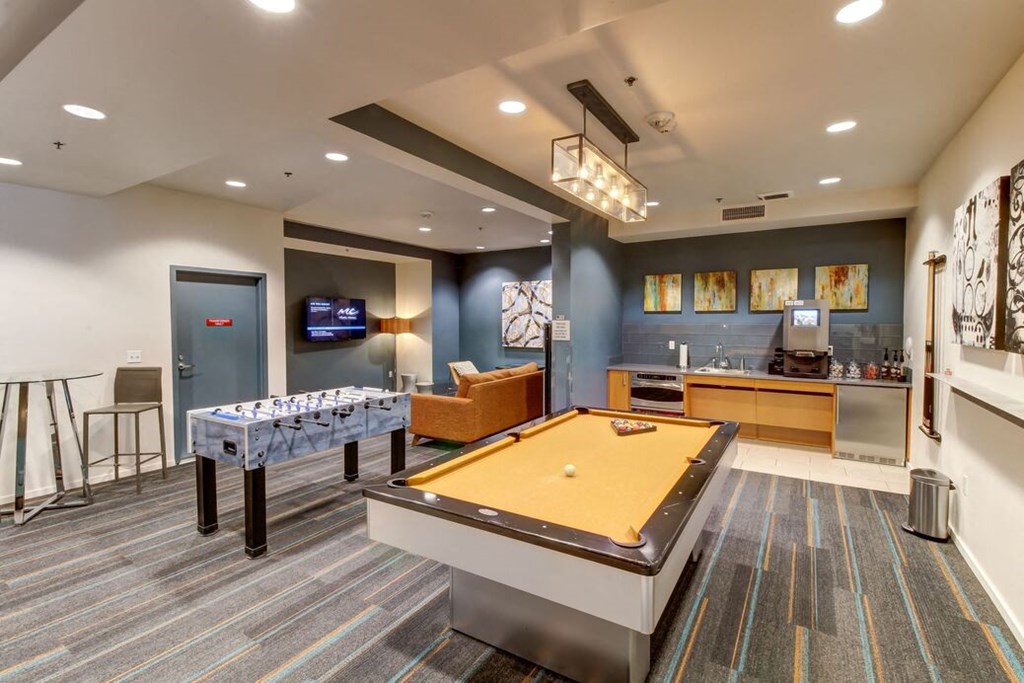 a games room with a pool table and foosball