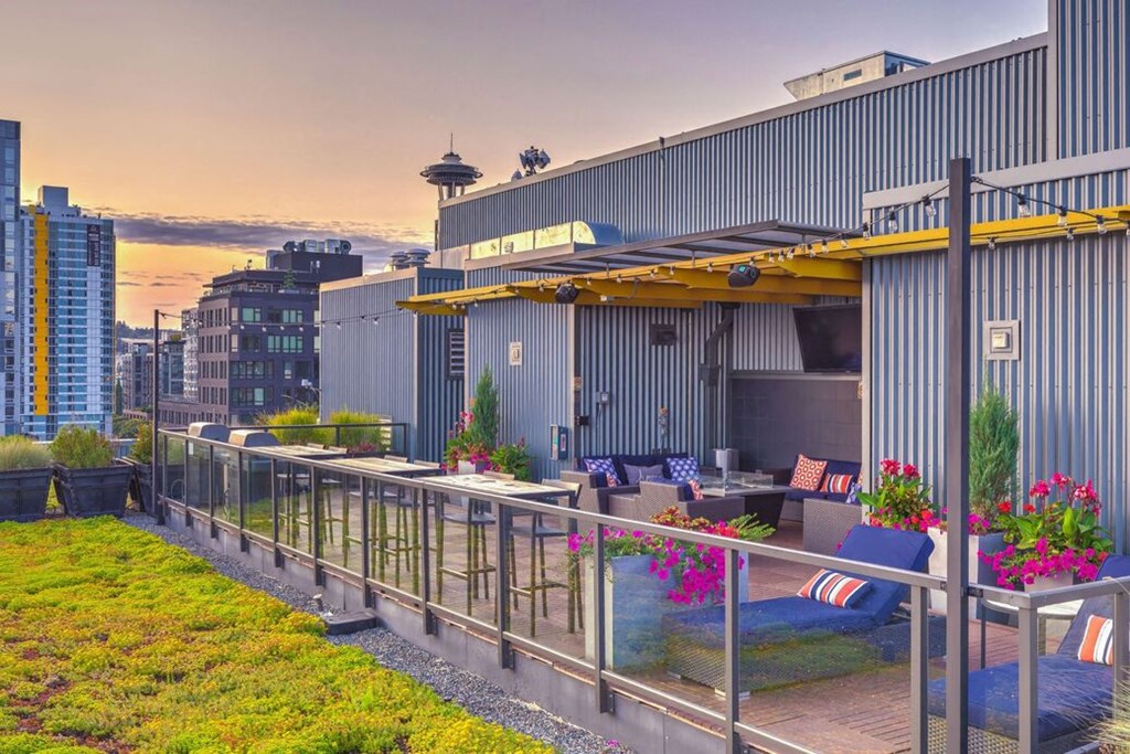 a rooftop patio with a view of the city