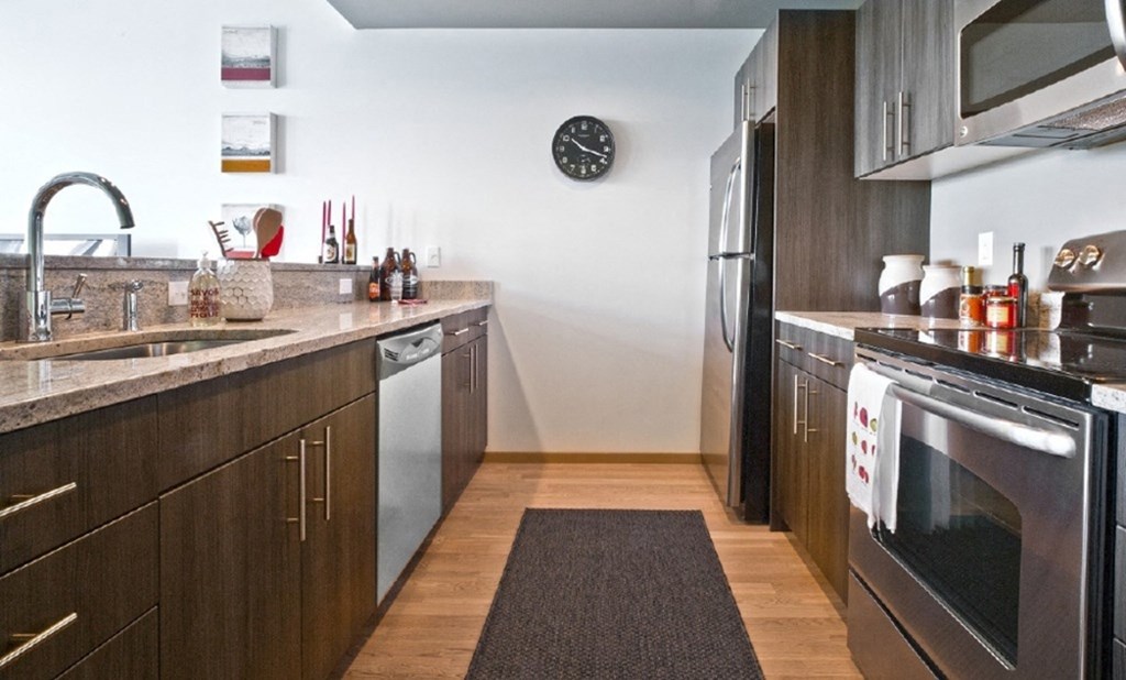 stainless steel kitchen with dark cabinets