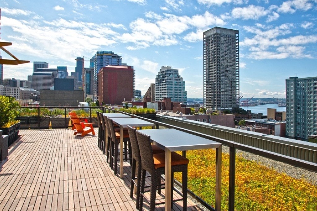 a rooftop deck with a view of the seattle skyline