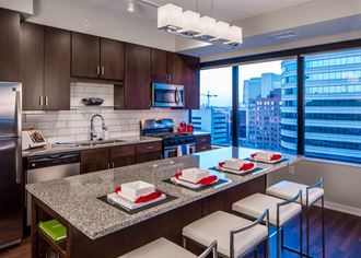 Nic on 5th Apartments in Minneapolis, Minnesota- Large modernized kitchen with wooden floors and granite counter tops