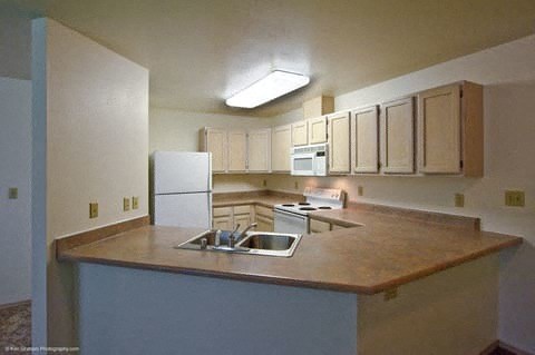 Bright Park-a kitchen with a counter top and a refrigerator