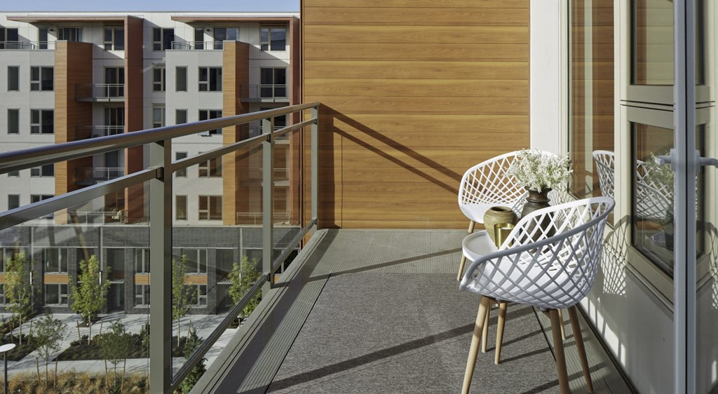 a balcony with a chair and a table on it