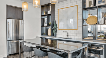 a kitchen with stainless steel appliances and a marble counter top