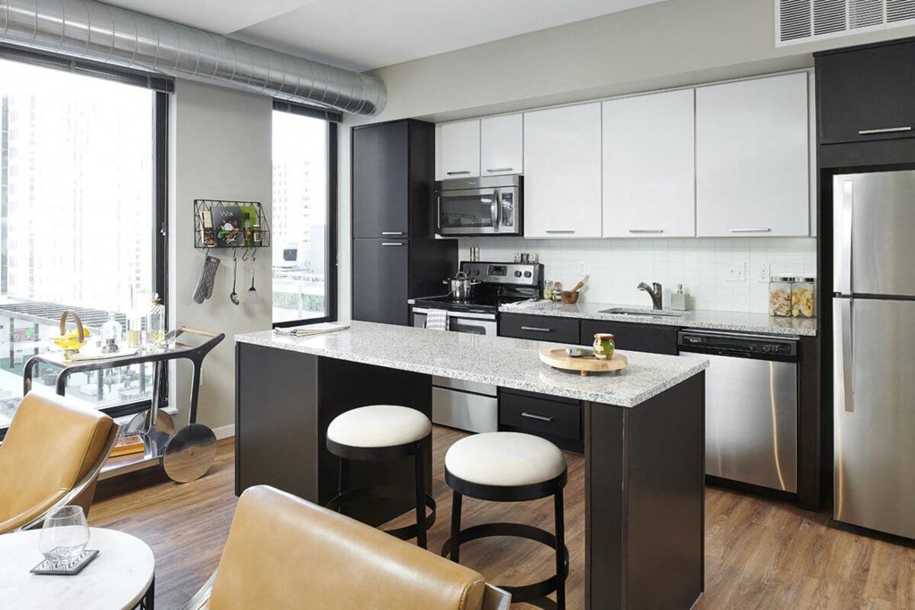 4Marq - Kitchen With Stainless Steel Appliances and Large Windows