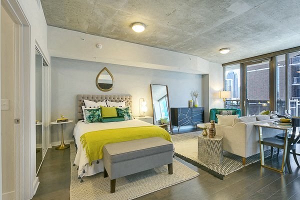 a bedroom with a bed and a living room