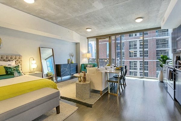 a living room with a bed and a dining room