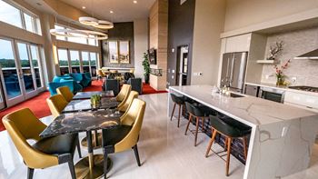 a kitchen and dining room with a marble counter top and chairs