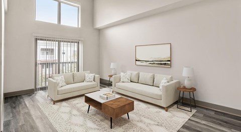 A living room with two couches, a coffee table, and a painting on the wall.