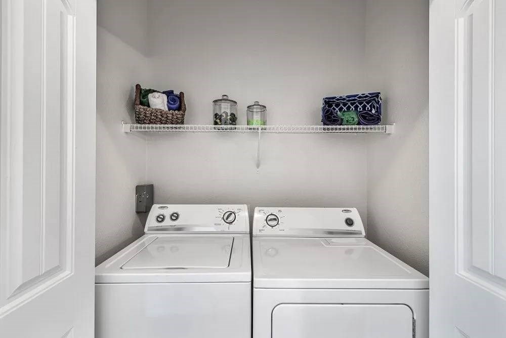 A small laundry room with a washer and dryer.