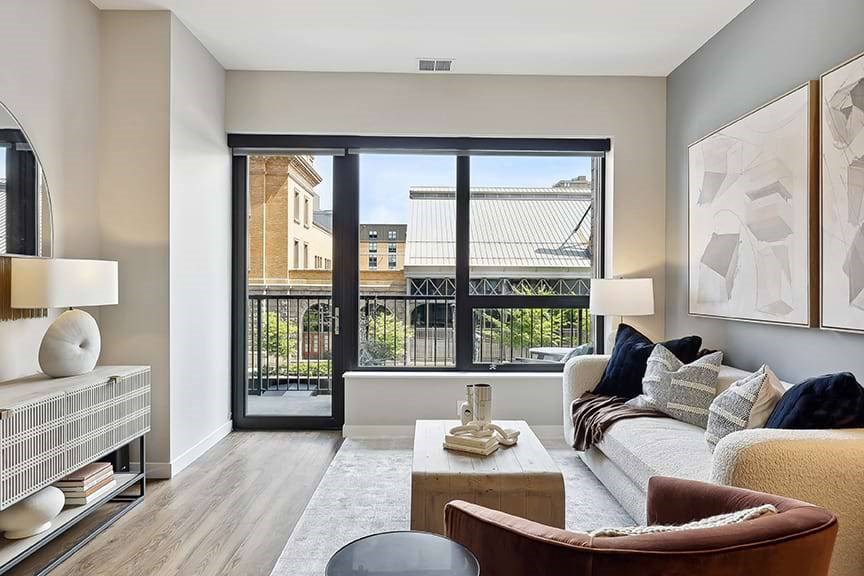 A modern living room with a large window and a view of a cityscape.