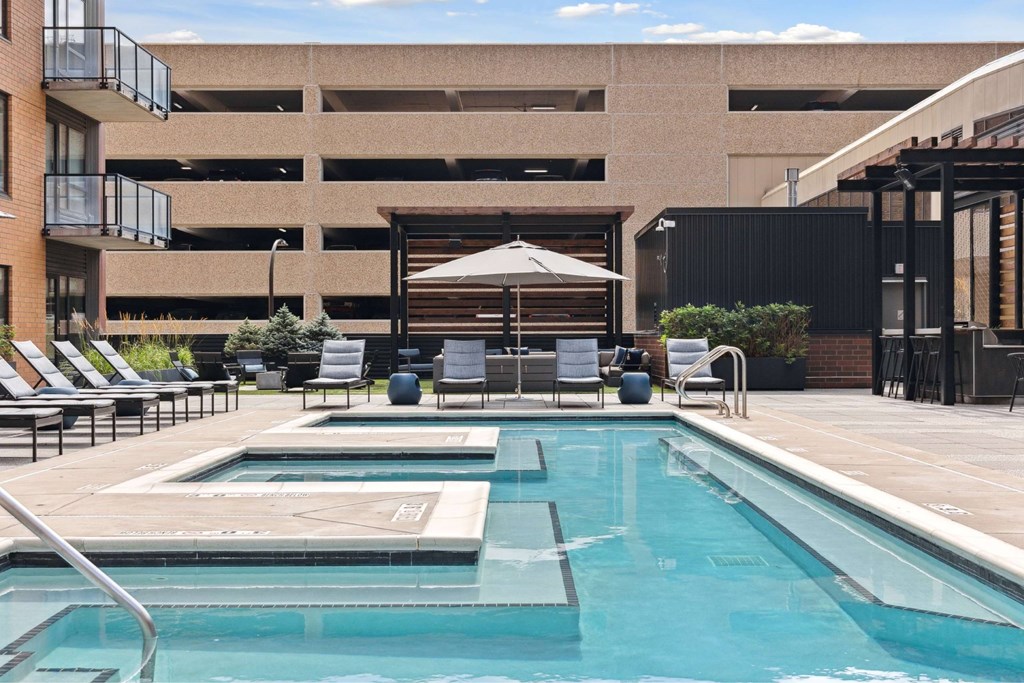 A pool area with chairs and a canopy.