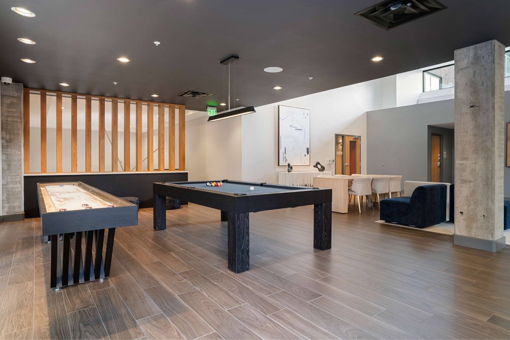 A room with a pool table and a billiard table.