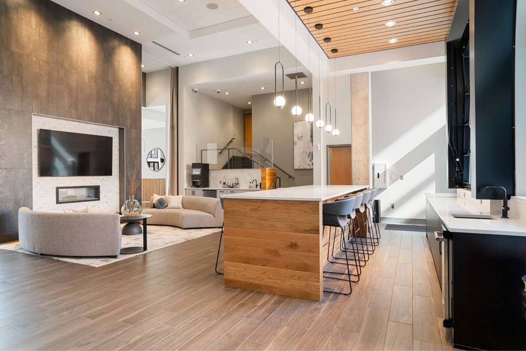 A modern kitchen with a wooden island and a fireplace.