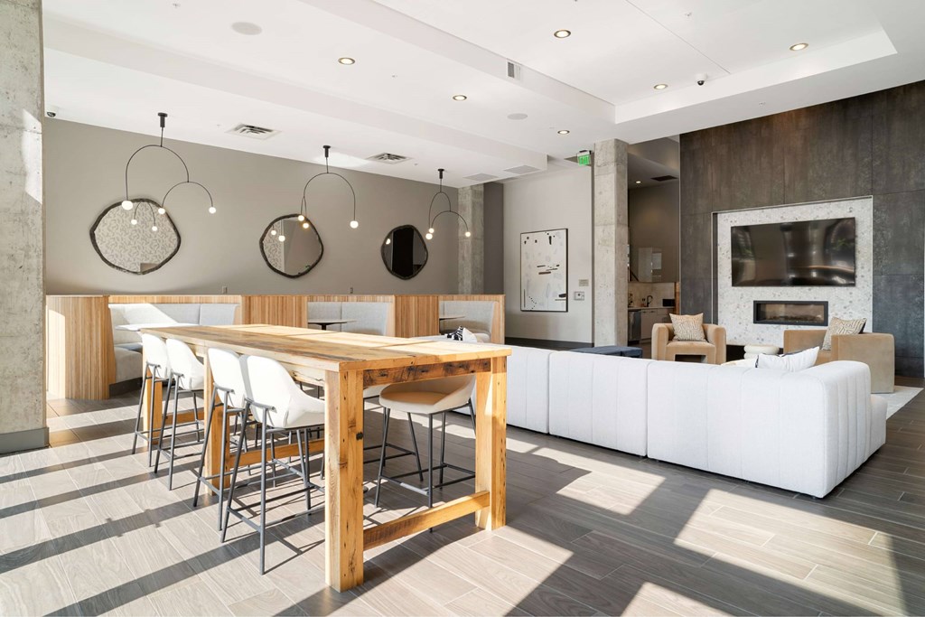 A modern dining room with a wooden table and chairs.