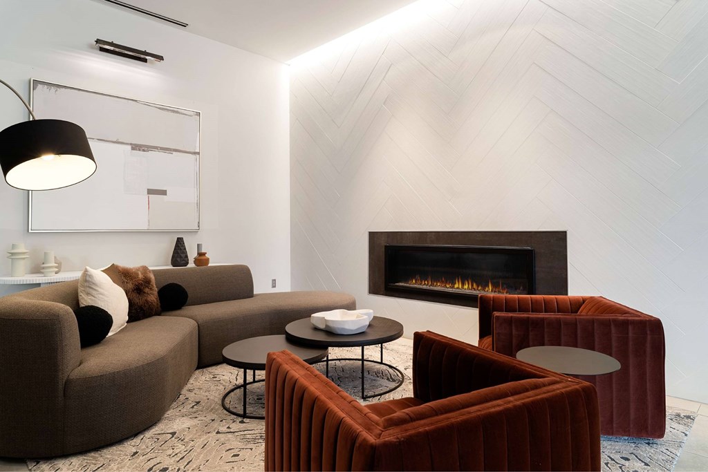 A modern living room with a fireplace and a couch.