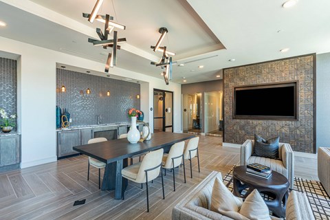 A modern dining room with a large table and chairs.