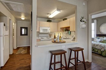 A kitchen with light cabinets and white appliances Pala Mesa Kitchen - Photo Gallery 3