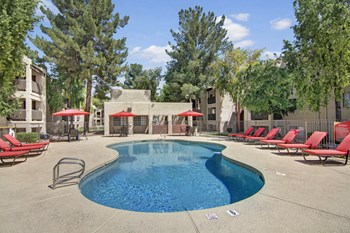An outdoor pool with lounge chairs Property Image