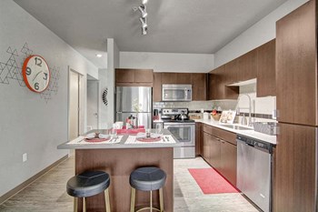 A kitchen with stainless steel appliances and an island Proxy 333 Kitchen - Photo Gallery 2