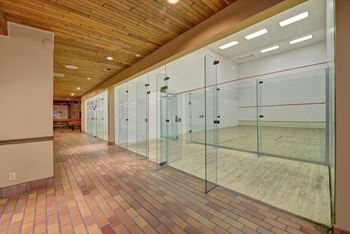 a squash court with glass doors