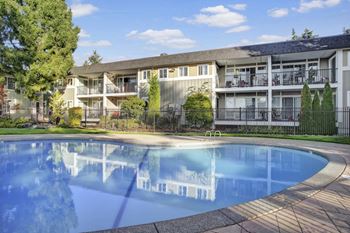 a swimming pool in front of an apartment building