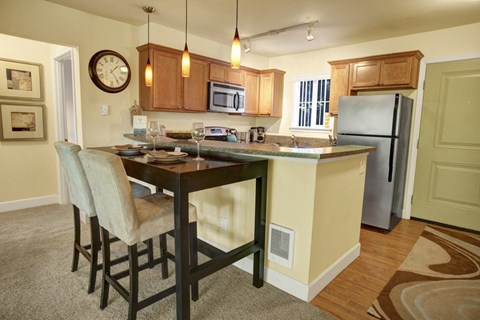 a kitchen with a large island with a breakfast bar