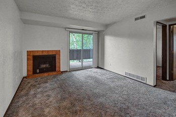 A living room with a fireplace and sliding glass doors Russian Jack Living Room - Photo Gallery 5
