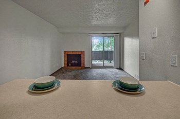 A living room with a fireplace and sliding glass doors Russian Jack Living Room - Photo Gallery 4