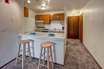 A kitchen with wood cabinetry and white appliances Russian Jack Kitchen - Photo Gallery 3