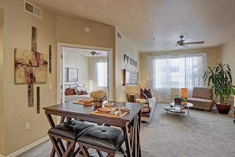 A dining room with a wooden table and chairs.
