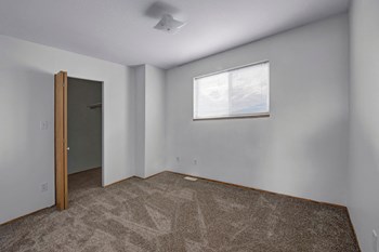 A bedroom with a large walk in closet Willowview Apartment Homes Bedroom