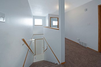The hall between bedroom next to the stairs leading down to the first level Willowview Terrace Apartment Homes Hall