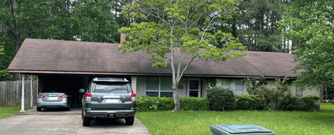 a house with a car parked in the driveway