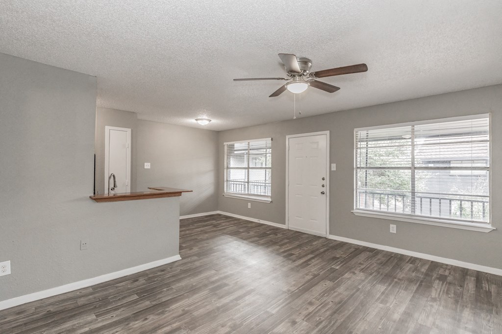 Open-concept living room with vinyl flooring at Chapel Creek Apartments Dallas