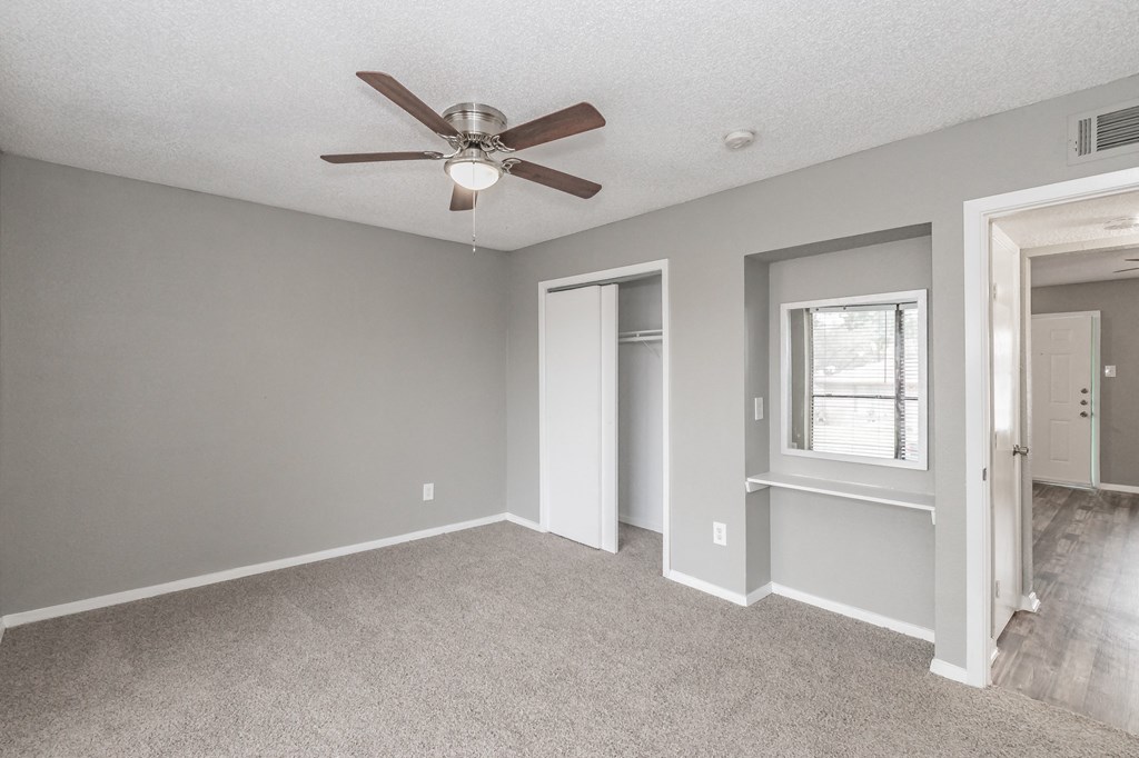 Bedroom with ceiling fan and neutral tones at Chapel Creek Apartments Dallas
