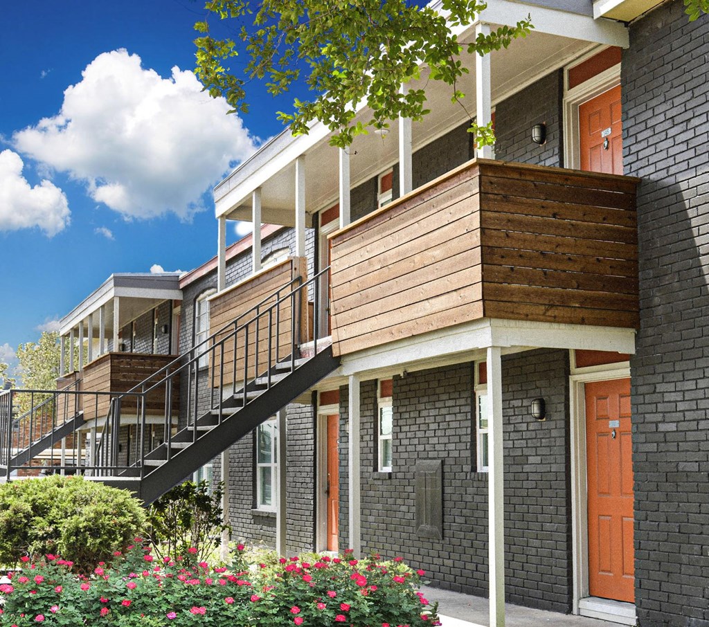 Apartment building with balconies and landscaping at Christy Estates Apartments