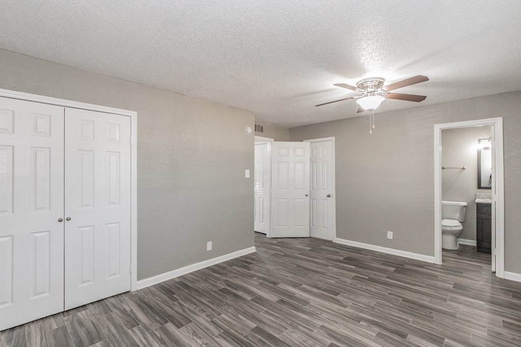 Bedroom with ceiling fan and neutral tones at Chapel Creek Apartments Dallas
