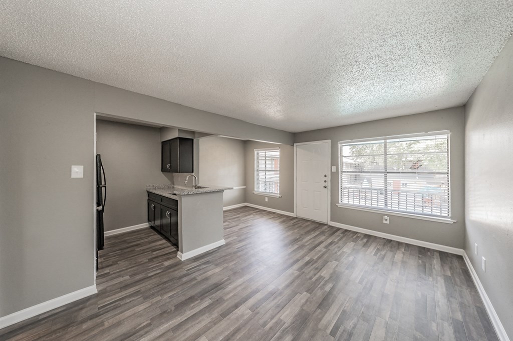 Kitchen with dark cabinets and granite-style countertops at Chapel Creek Apartments Dallas