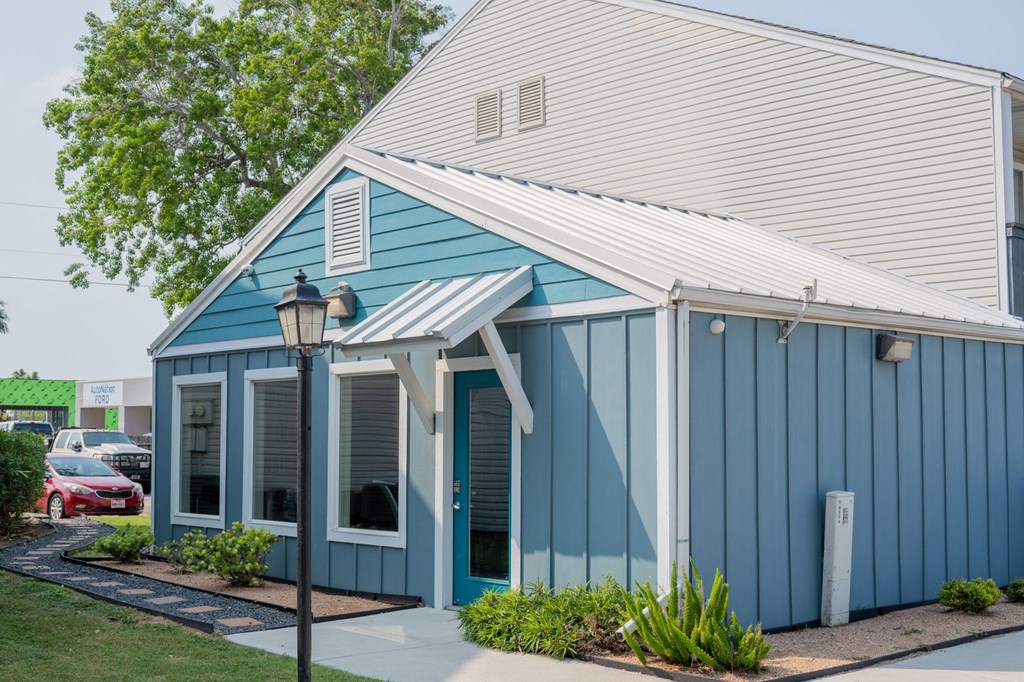 the exterior of a blue building with a white roof