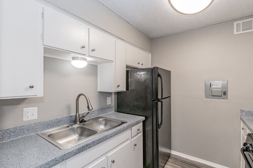 Kitchen with gas range and refrigerator at Davis Park Apartments in North Richland Hills TX