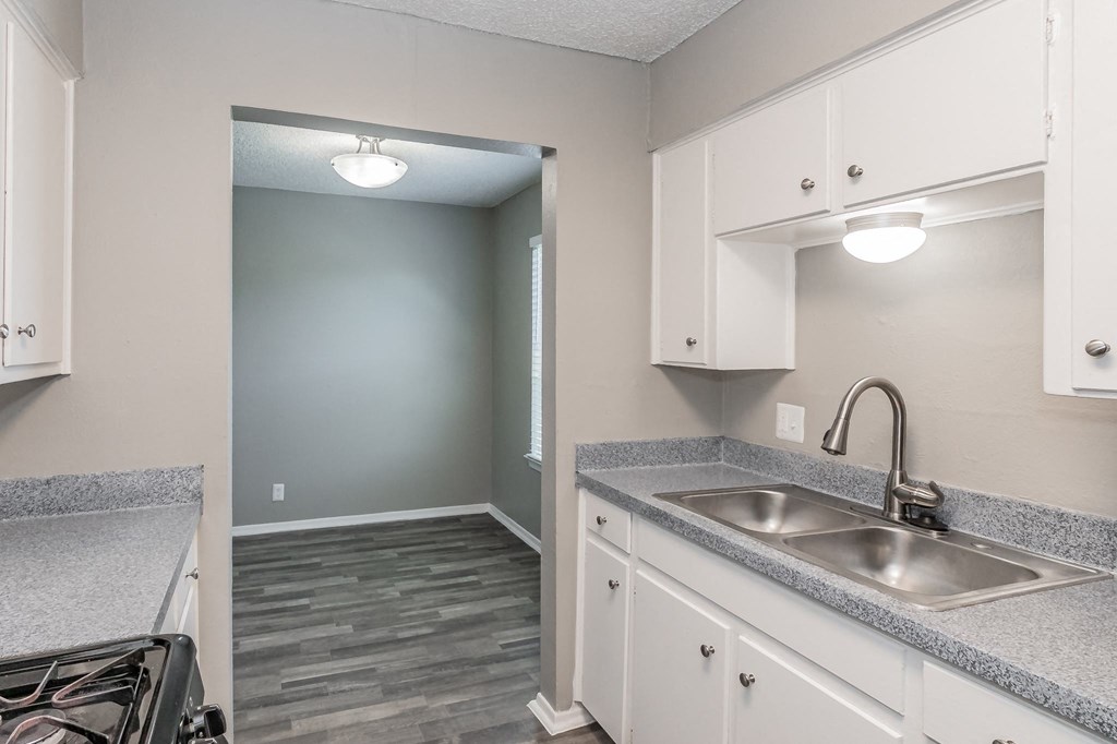 Kitchen with gas range and refrigerator at Davis Park Apartments in North Richland Hills TX
