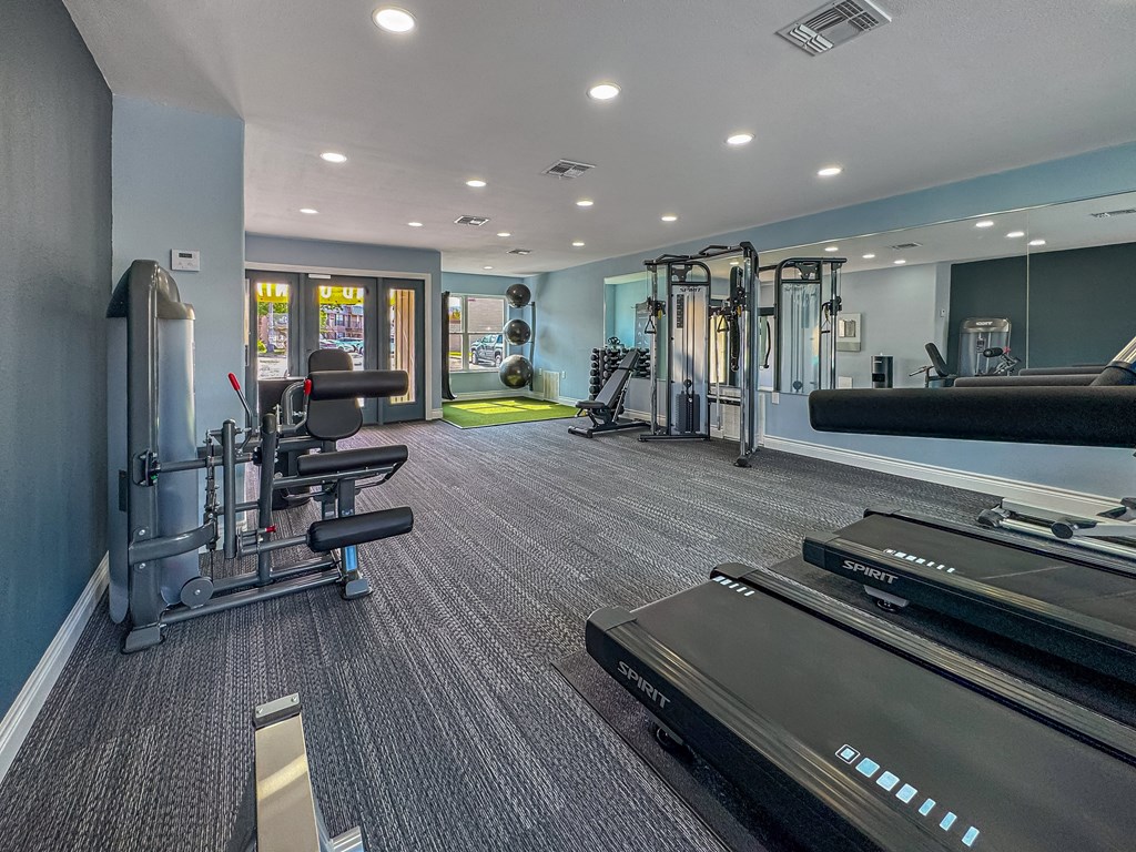 Fitness center with treadmills and weights – Borders Apartments Brownsville TX