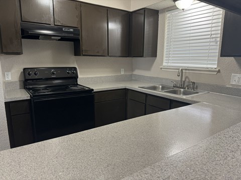 a kitchen with black appliances and a counter top