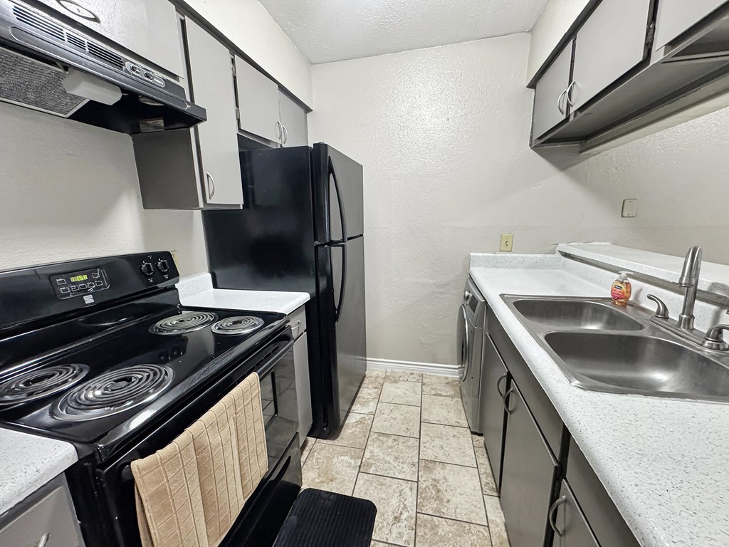 A black stove top oven with a towel on it.
